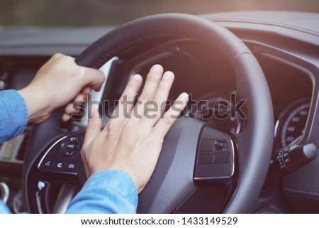 man pushing horn while driving sitting of a steering wheel press car, honking sound to warn other people in traffic concept. Royalty-Free Stock Photo #1433149529