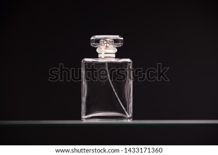 Perfume glass bottle on black background 