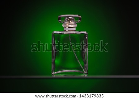 Perfume glass bottle on green background