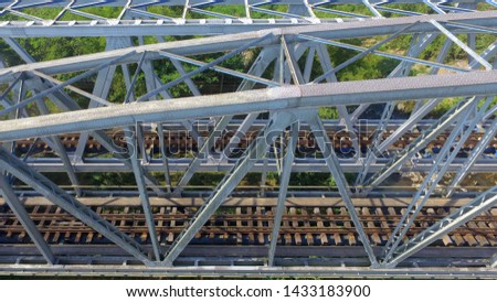 the infrastructure of the double railroad tracks and bridges can be seen from above through the aeria drone camera