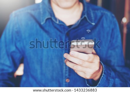 Businessman using mobile online icon social networking connection on screen