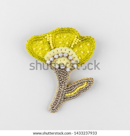 Brooch made of beads, sequins and threads. Yellow flower. Handmade jewelry. Crafts and creativity. Royalty-Free Stock Photo #1433237933