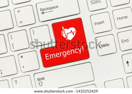Close-up view on white conceptual keyboard - Emergency (red key with cardiology symbol)
