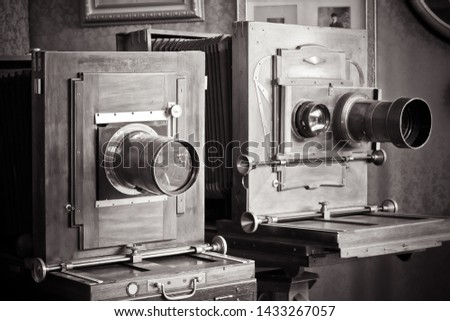 two vintage cameras with lenses.