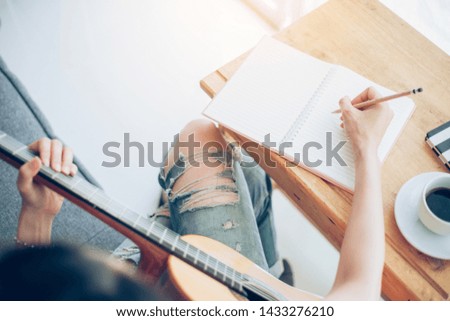 artist songwriter thinking writing notes,lyrics in book at studio.man playing live acoustic guitar relax chill.concept for musician creative.composer work process.people relaxing time with instrument.