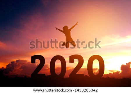 2020 Newyear Silhouette young woman jumping to Happy new year concept. Royalty-Free Stock Photo #1433285342