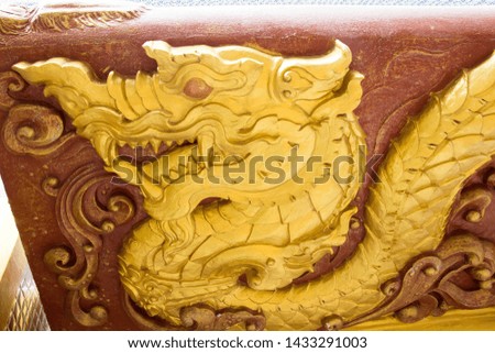 Golden dragon statue in wall