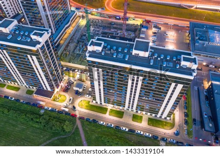 Aerial view from the heights of the night residential buildings in the city