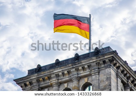 German flag waiving on Reichstag, Berlin Royalty-Free Stock Photo #1433326868