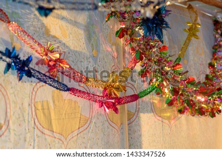 Colorful Sukkah decoration shiny garland at sunset light.