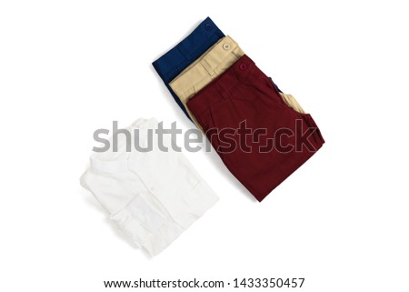 Folded white mandarin collar linen shirt and navy khaki red chino pants . Isolate on white background with space
