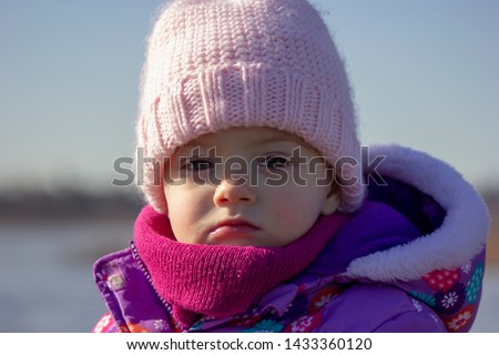 20 months old baby enjoying the nice weather outside. Toddler girl portraits in natural light. Little girl close up picture in nature, in Winter at Burnaby Lake, BC, Canada