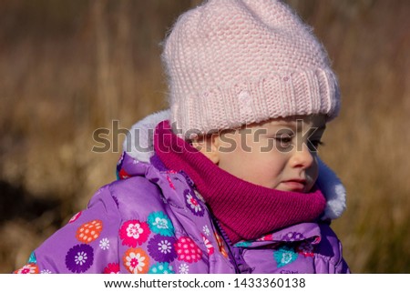 20 months old baby enjoying the nice weather outside. Toddler girl portraits in natural light. Little girl close up picture in nature, in Winter at Burnaby lake, BC, Canada
