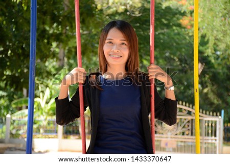 Asian women smile happily On the playground