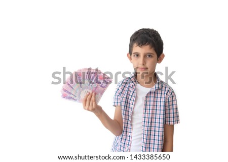 Portrait of a teenager holding ukrainian money hryvnia isolated on white background.