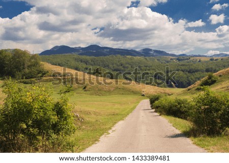 Mountain landscape and road in the autumn cloudy day.