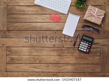 creative workspace office desk on top view with keyboard, tablet pc, smartphone, notepad, pen, plant and cup of coffee with copy space for text