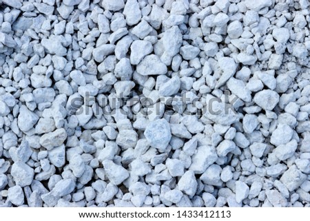 pictured in the photo gray background consisting of small gray stones
