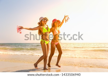 Couple girl running on the beach relaxing summer vacation.Young fashion woman relax on the beach. Happy island lifestyle.crystal. Vacation at Paradise. Ocean beach relax. Royalty-Free Stock Photo #1433506940