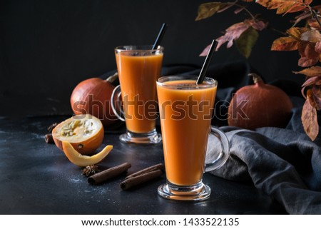 Fresh pumpkin spice smoothie or juice on dark. Autumn, fall or winter hot drink on dark black background. Cozy healthy beverage. Close up. Thanksgiving drink.