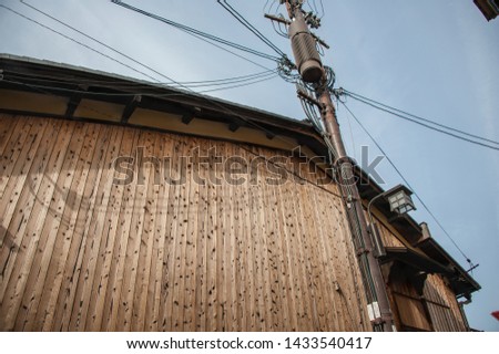 Overhead power lines and old wooden building in the Gion District of Kyoto, Japan