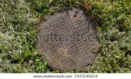 old and rusty manhole on the street top view