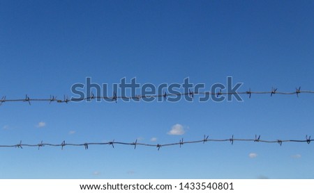 barbed wire against blue sky at daytime