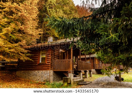 beautiful wooden house in the mountains in Autumn. House in the forest. Vacation in wood. Holidays in the nature