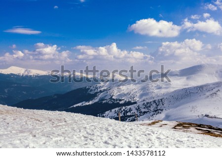 Snowy mountain landscape against blue sky