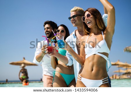 Summer party. Friends at beach drinking coctails and having fun