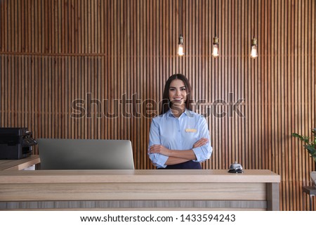 Portrait of receptionist at desk in lobby Royalty-Free Stock Photo #1433594243