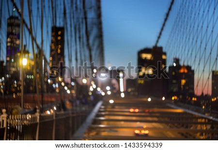 Blurred urban traffic Brooklyn Bridge at twilight in New York City scene at night