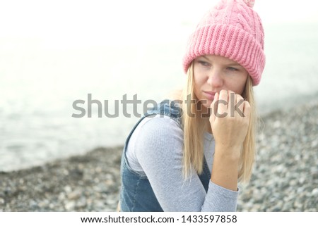 Portrait of beautiful blond girl in wool hat