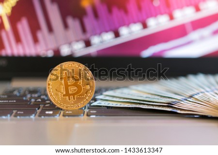 bitcoin, chart and us dollar. Finance trading. Dollar bills laying on a laptop with bitcoin charts on a blurred background