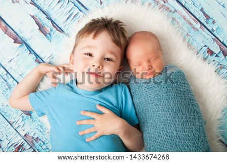 Proud new big brother and newborn baby little brother. Newborn and sibling portrait.  Royalty-Free Stock Photo #1433674268