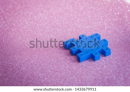 Colorful plastic puzzle pieces on pink Background.