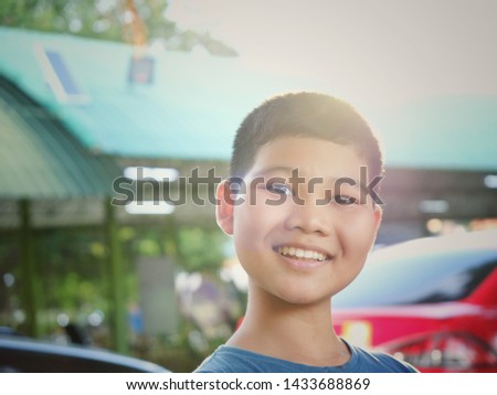 Portrait young asian boy standing in the garden.
