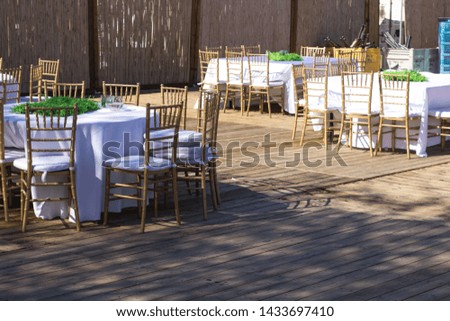 patio restaurant exterior environment with tables and chairs empty wooden furniture 