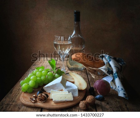 Still life with cheese Brie and grapes