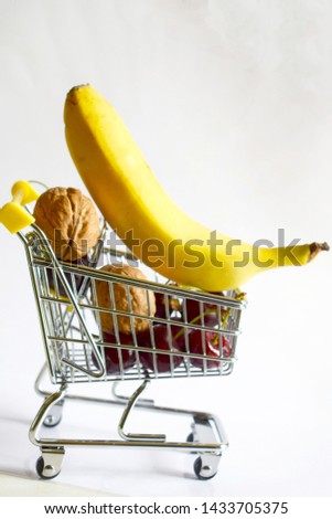  shopping cart with nuts and banana Royalty-Free Stock Photo #1433705375