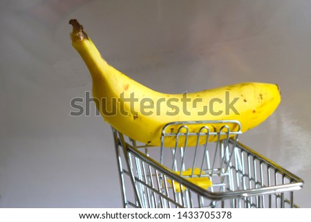 metal shopping cart with only one banana Royalty-Free Stock Photo #1433705378