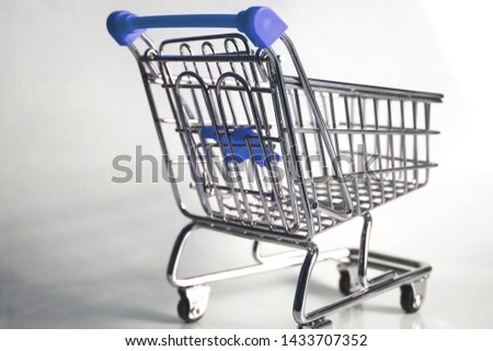 blue metal shopping trolley whit white background Royalty-Free Stock Photo #1433707352