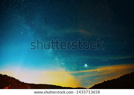 Midsummer Milky Way, Jupiter, Saturn and satellite light in the night sky.