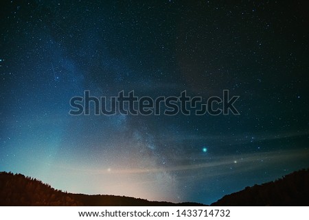 Midsummer Milky Way, Jupiter, Saturn and satellite light in the night sky.
