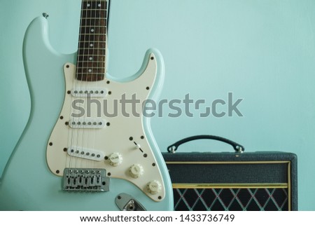 light blue guitar and amplify for jamming music