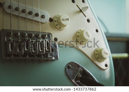 light blue guitar knobs close up