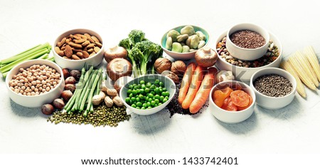 Food sources of plant based protein. Healthy diet with  legumes, dried fruit, seeds, nuts and vegetables.  Foods high in protein, antioxidants, vitamins and fiber. Panorama, banner Royalty-Free Stock Photo #1433742401