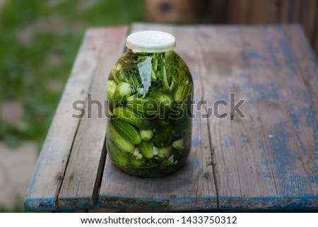 three-liter jar with cucumbers on the table