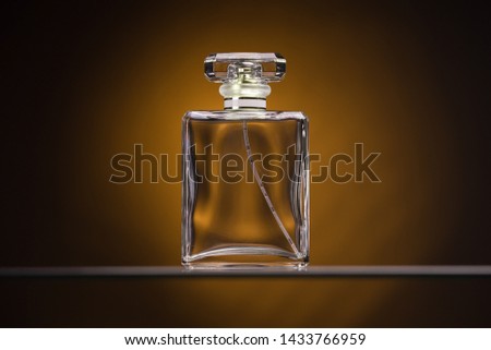 Perfume glass bottle on yellow background