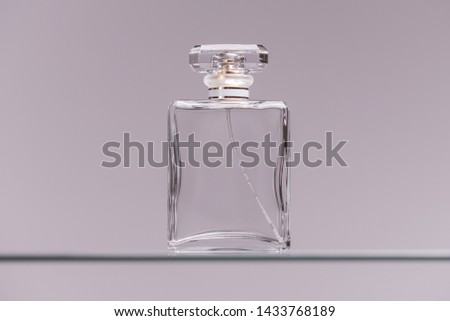Perfume glass bottle on gray background